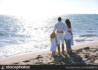 happy young family in white clothing have fun at vacations on beautiful beach