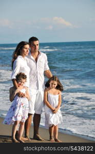 happy young family in white clothing have fun at vacations on beautiful beach