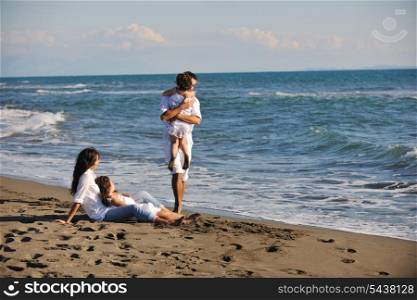 happy young family in white clothing have fun at vacations on beautiful beach