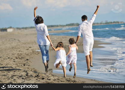 happy young family in white clothing have fun at vacations on beautiful beach