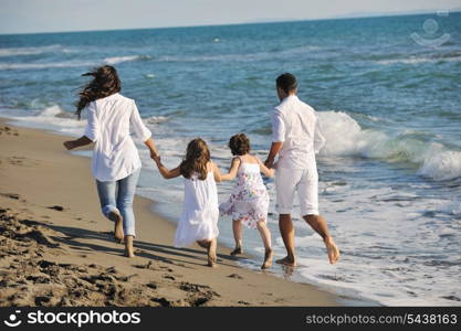 happy young family in white clothing have fun at vacations on beautiful beach