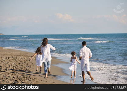 happy young family in white clothing have fun at vacations on beautiful beach