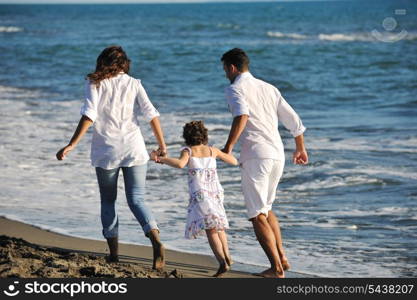 happy young family in white clothing have fun at vacations on beautiful beach