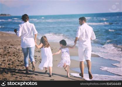 happy young family in white clothing have fun at vacations on beautiful beach