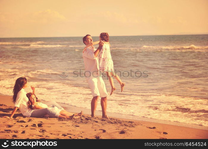 happy young family in white clothing have fun at vacations on beautiful beach