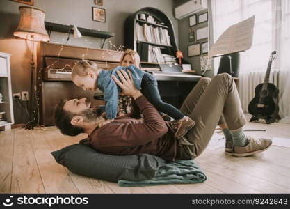 Happy young family playing on the floor  in the room