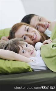 happy young family relaxing in bed