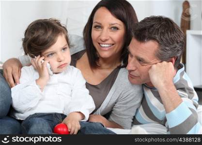 Happy young family sat together