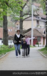 happy young family walking outdoor in park