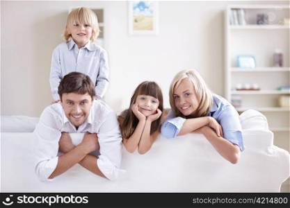 Happy young family with children at home