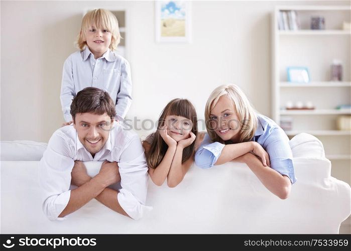 Happy young family with children at home