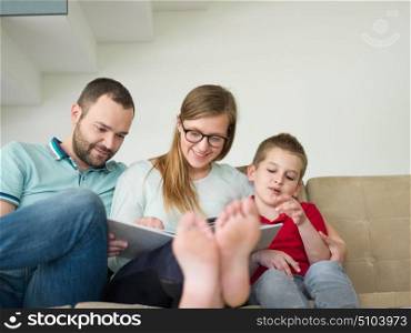 happy young family with little boy enjoys in the modern living room of their luxury home villa