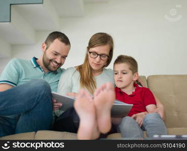 happy young family with little boy enjoys in the modern living room of their luxury home villa