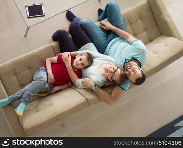 happy young family with little boy enjoys in the modern living room of their luxury home villa