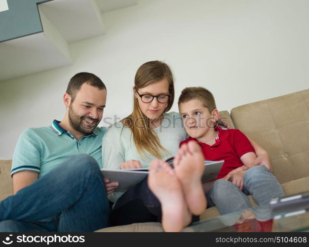 happy young family with little boy enjoys in the modern living room of their luxury home villa