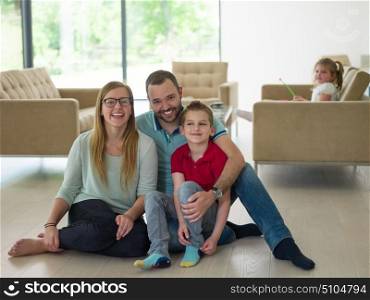 happy young family with little boy enjoys in the modern living room of their luxury home villa
