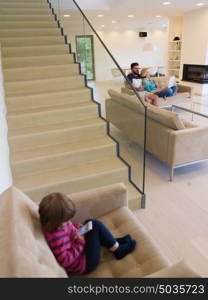 happy young family with little girl enjoys in the modern living room of their luxury home villa