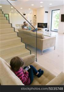 happy young family with little girl enjoys in the modern living room of their luxury home villa
