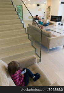 happy young family with little girl enjoys in the modern living room of their luxury home villa