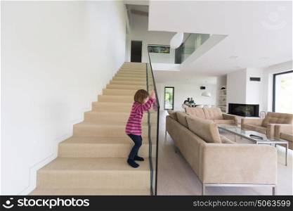 happy young family with little girl enjoys in the modern living room of their luxury home villa