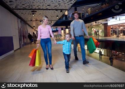 happy young family with shopping bags in mall