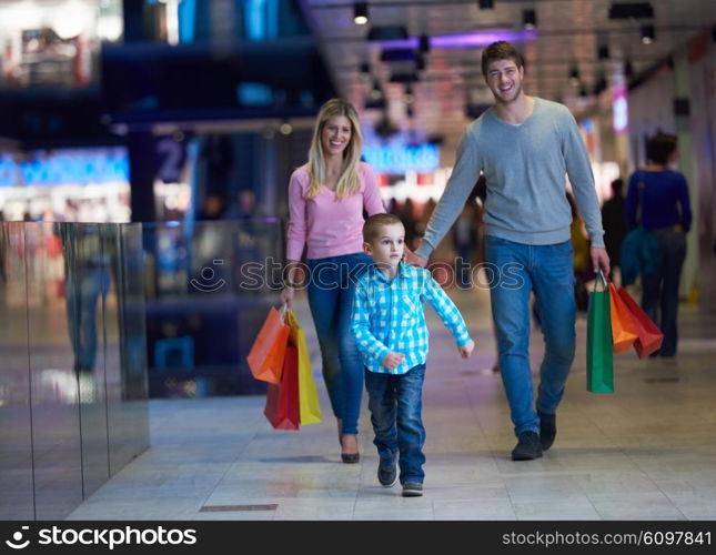 happy young family with shopping bags in mall