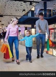 happy young family with shopping bags in mall