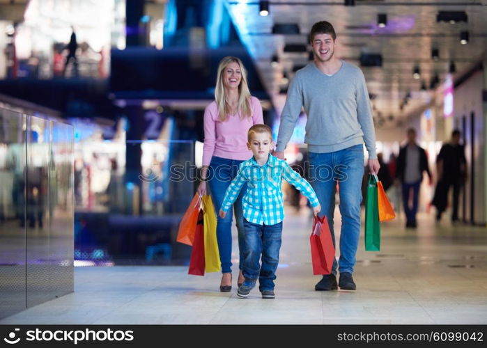 happy young family with shopping bags in mall