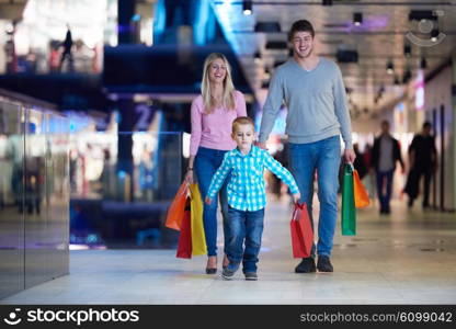 happy young family with shopping bags in mall