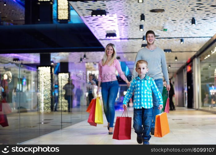 happy young family with shopping bags in mall