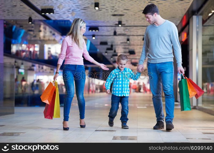 happy young family with shopping bags in mall