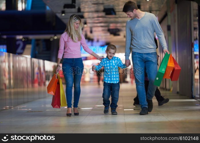 happy young family with shopping bags in mall