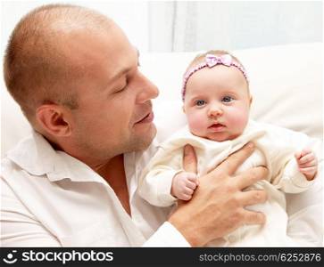 Happy young father with newborn baby girl, closeup portrait