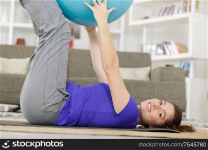 happy young female doing exercises at home
