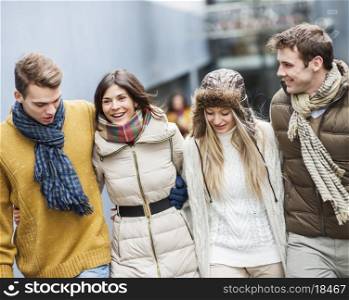 Happy young friends walking together outdoors