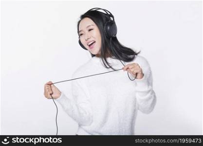 Happy young girl listening to music