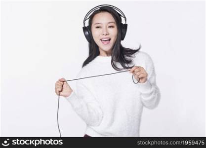 Happy young girl listening to music