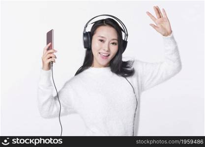 Happy young girl listening to music on her mobile phone