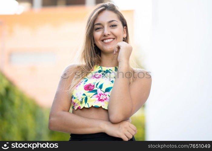 Happy young girl with beautiful straight hair standing outdoors. Happy young girl with beautiful straight hair
