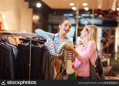 happy young girls in shopping mall, friends having fun together