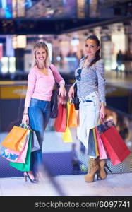 happy young girls in shopping mall, friends having fun together