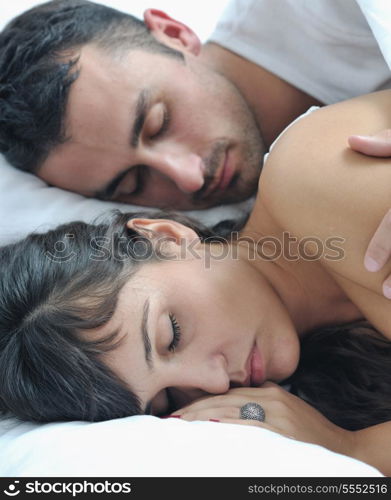 happy young healthy people couple have good time in their bedroom make love and sleep