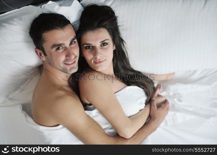 happy young healthy people couple have good time in their bedroom make love and sleep