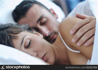 happy young healthy people couple have good time in their bedroom make love and sleep