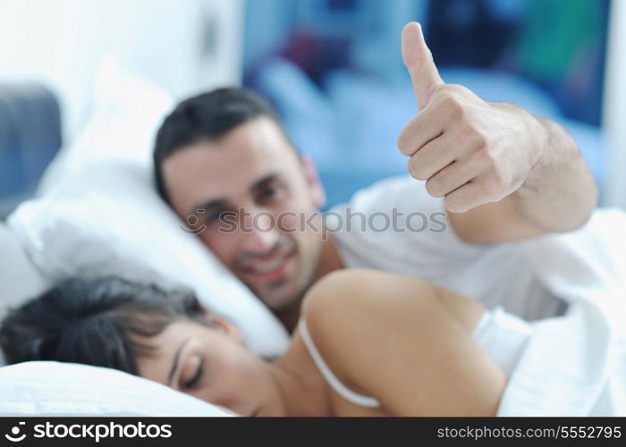 happy young healthy people couple have good time in their bedroom make love and sleep