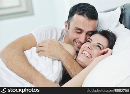 happy young healthy people couple have good time in their bedroom make love and sleep