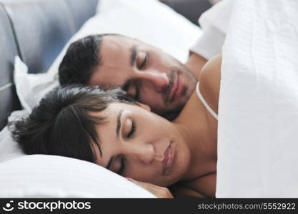 happy young healthy people couple have good time in their bedroom make love and sleep