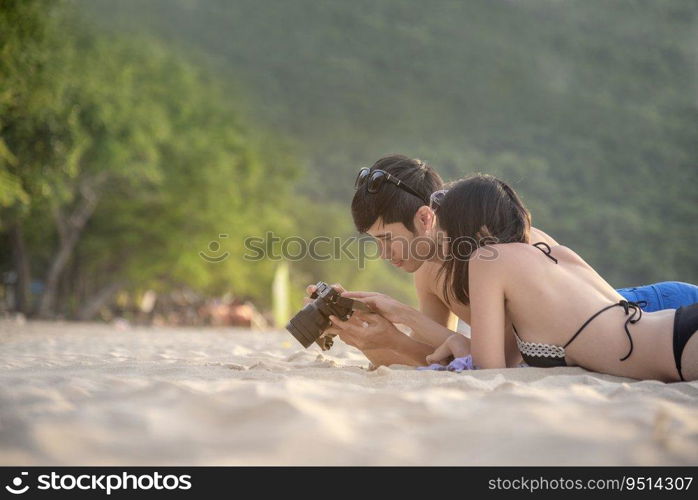 Happy young honeymoon couple on beach having vacation fun at paradise tropical island beach on sunny day. Young couple relax on white sand beach. Couple in love valentine honeymoon travel concept.