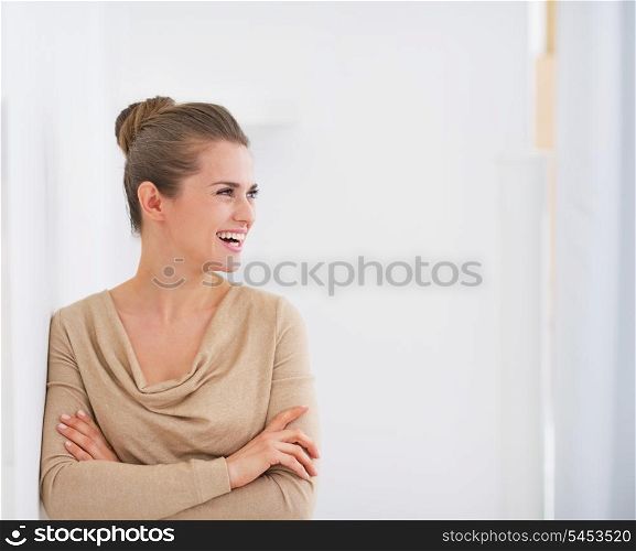 Happy young housewife looking on copy space