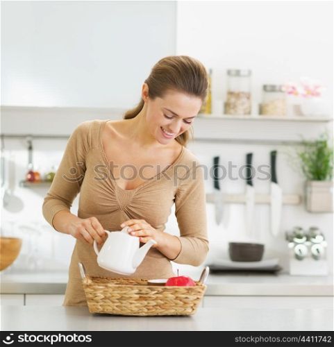 Happy young housewife serving breakfast tray
